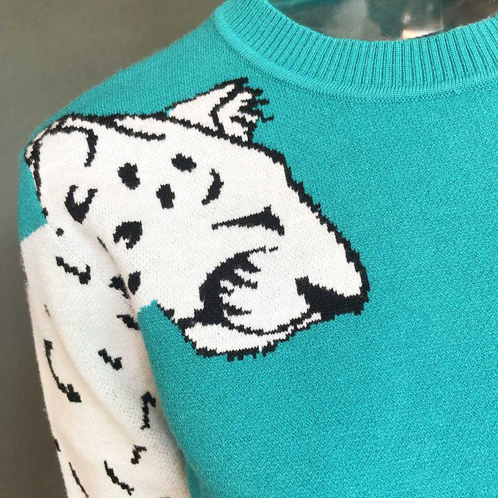 Green sweater top with leopard sleeves
